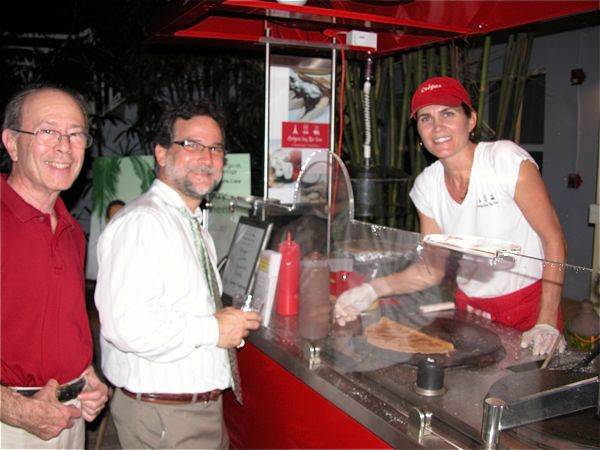 Bettina Seifts of Crepes by the Sea serves Bob Schwartz of Concensus and Salomon Romano of National Estate Buyers Group. Crepes by the Sea was one of the sponsors of the event. 