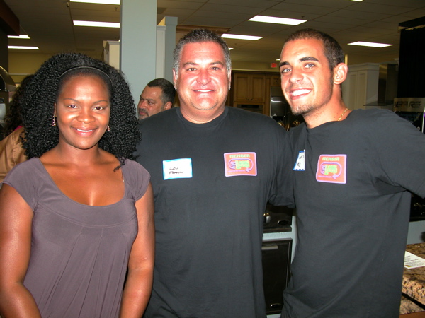   Daphne Antoine of Credulus Systems International, left, with Lou Franco and Garry S. Marsh, both of Local Loop. 