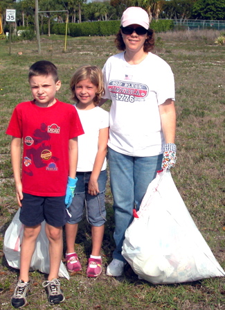 3 people picking up litter