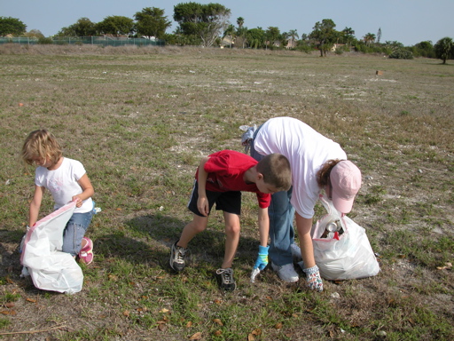 2 kids and mom picking up litter