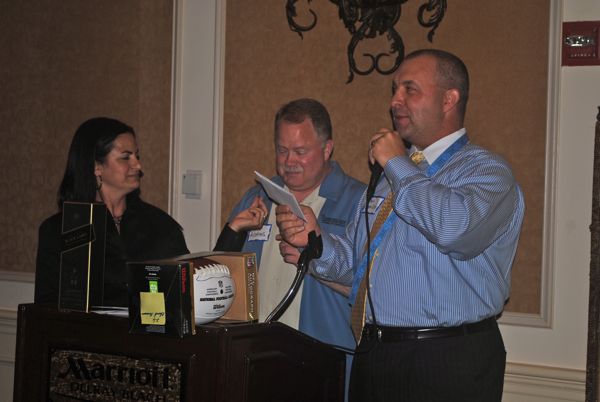 Geri Castrillon and Dave Adams assist Dan Castrillon as he handles raffle duty during the event. 