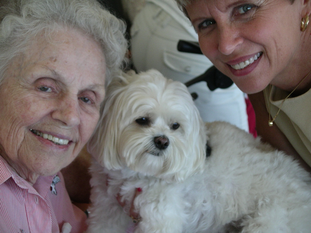 Kelli Freeman, right with CoCo, her therapy dog and a patient. Freeman and CoCo help about 200 patients a week by volunteering at five facilities in Palm Beach and Broward counties.   