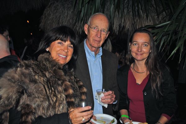 Two women and a man enjoying the party.