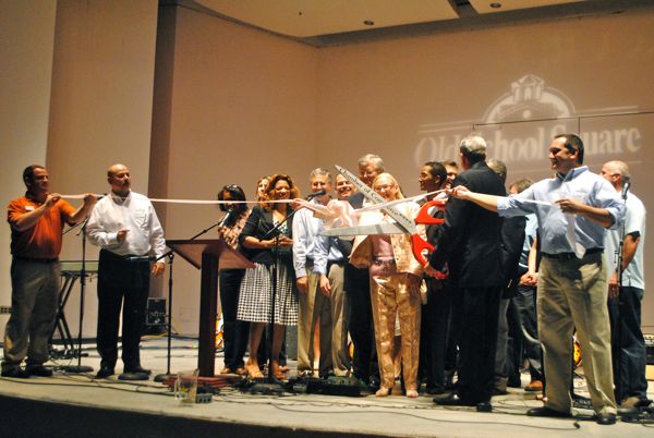 Delray Beach Mayor Woodie McDuffie, scissors in hand, cuts the ribbon as Old Schhol Square officially become the Delray Beach Center for the Arts.