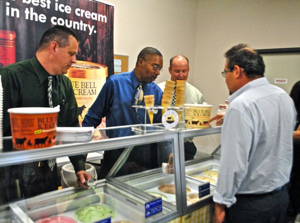 Francisco Perez-Azua decides what flavor of ice cream he wants to sample. Serving him are Blue Bell employees Jerry Jones, left, Isaiah Palmer and Henry Paine.