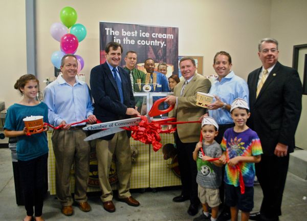 Gregg Weiss and Mike Malone of the Delray Beach Chamber of Commerce, left, assist Blue Bell Creameries' Jim Wiederholt cut the ribbon on the ice cream company's new distribution center. Delray Commissioner Adam Frankel and Mayor Woodie McDuffie also were on hand for the event. 