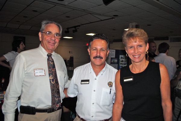 Arnold Jacobs of Lang Real Estate, left, with Marc Melnick of Carpenter Security Integrators and Kelli Freeman of the Hamilton House. 