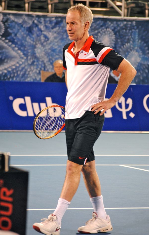 McEnroe walks to the net, protesting a call. "Anyone see that?" he asks the 50 or so remaining in the stadium after the rain delay. 