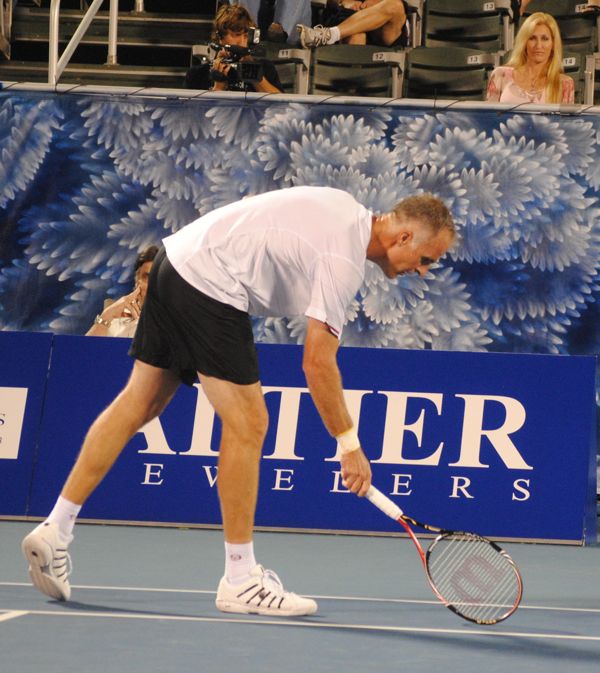 Todd Martin taps the court with his racket, showing the spot out of bounds where he thought a shot had landed. 