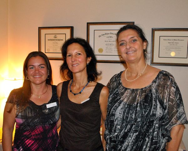 Dr. Delia Weiss, center, with office manager Julia Severin, left and Barbara from the Orchid Room, at the grand opening of her downtown Delray Beach medical office. 