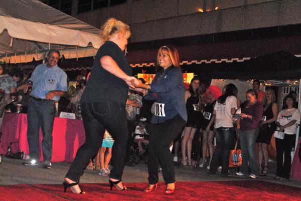 Valerie Encheff and Connie Bowser, both of SK Quality Roofing, show their stuff during the Stiletto Strut portion of the competition.